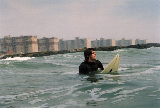 Trevor Dye, a recent NYU graduate, waits for a wave off Rockaway Beach
in Queens. PHOTO: Carl Critz.