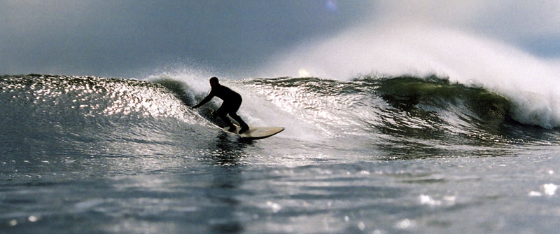 An unknown surfer glides along a perfect wave off Rockaway Beach. PHOTO: Carl Critz.