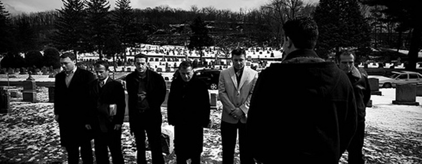 Eight former KLA soldiers of the Atlantic Battalion gather in front of the Bytyqi brothers’ graves to pay their respects. Gani Shehu, the Battalion’s former commander, gives a brief speech to the men, standing from left to right: Florim Lajqi, Sadrixh Mehaj, Adrian Grajcevci, Feriz Gjevukaj, Nok Nokaj, Fadil Idrizi, and Uran Rexhepi. St. Mary's Cemetery, Yonkers, NY. March 1, 2008. Photo by Nicole Tung