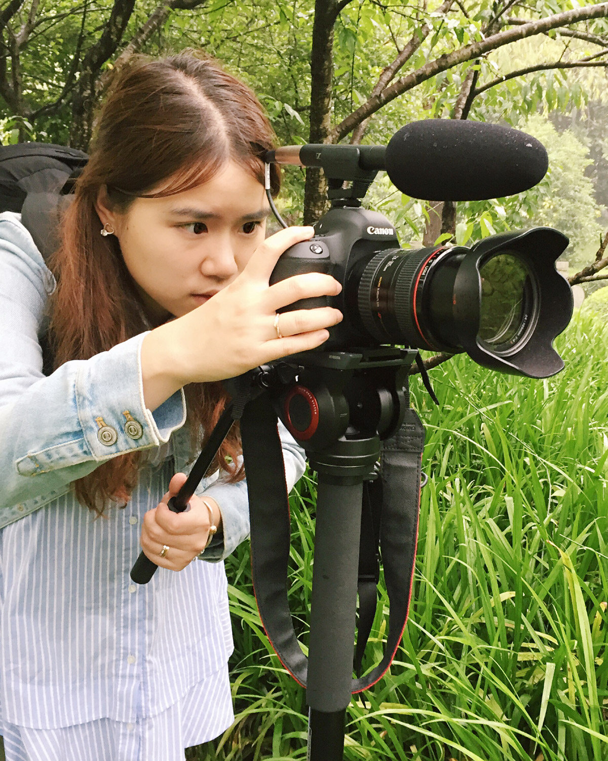 Student recording with camera outside