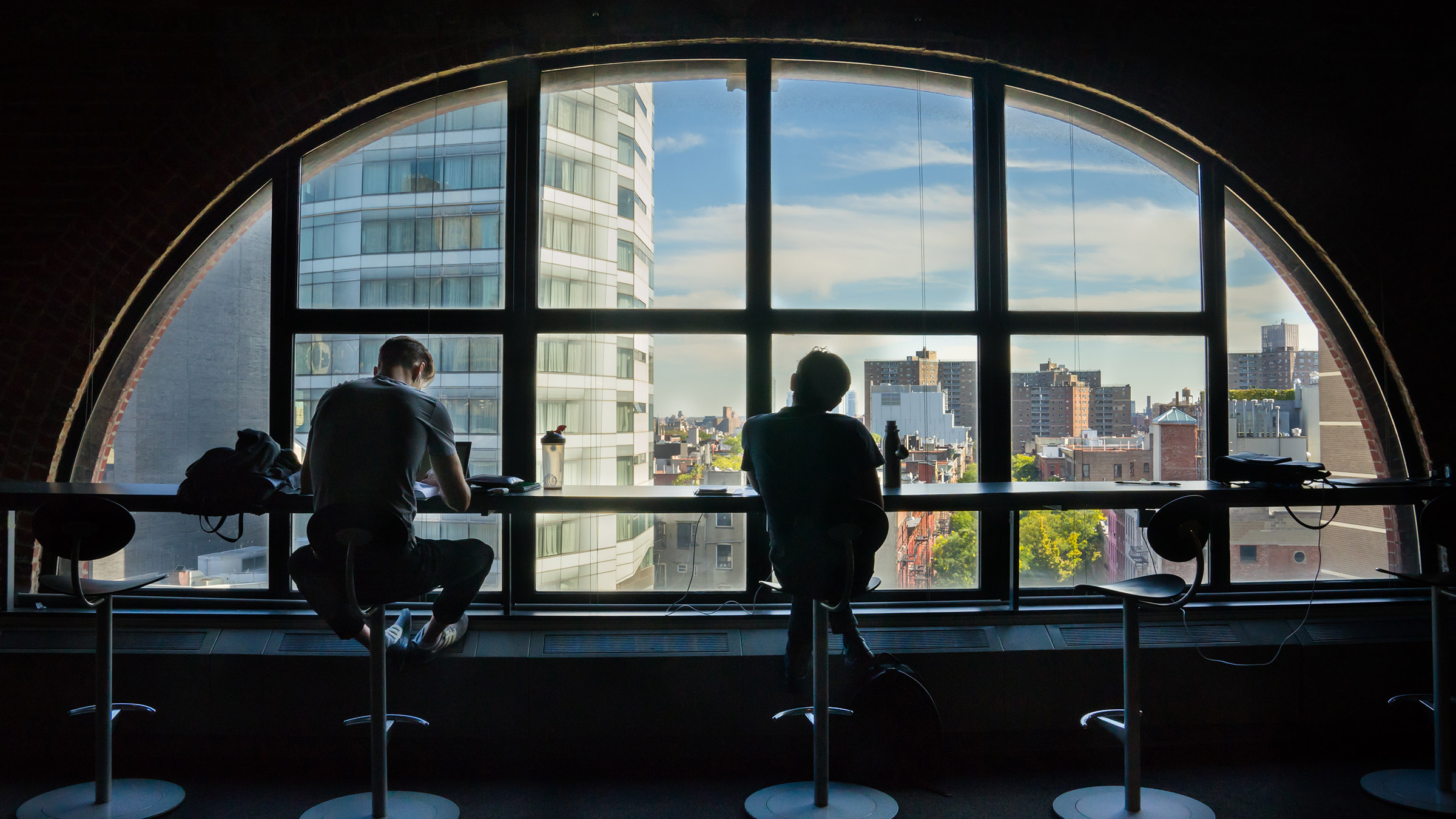 Students in front of common area window overlooking NYC