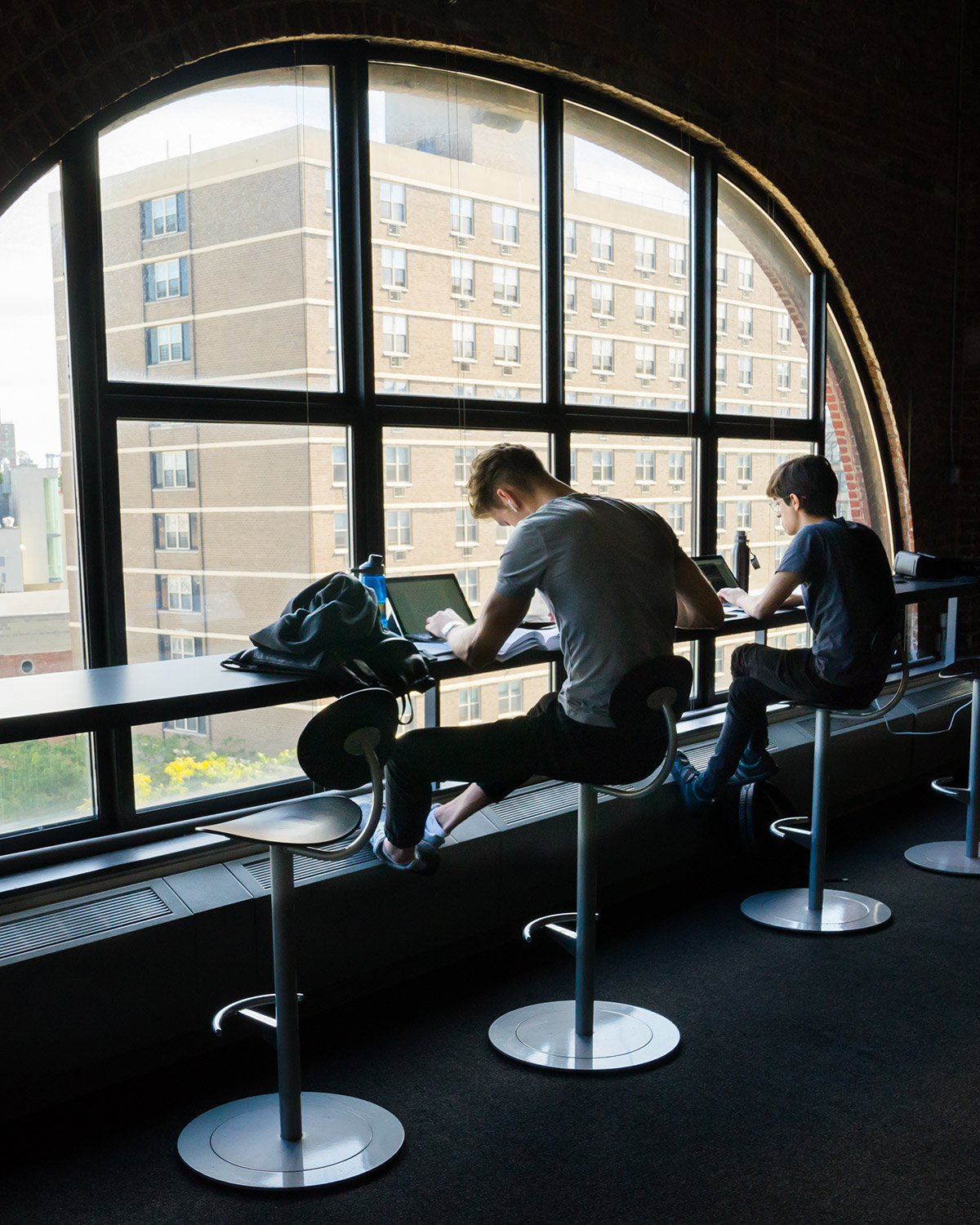 Students studying at window in common area