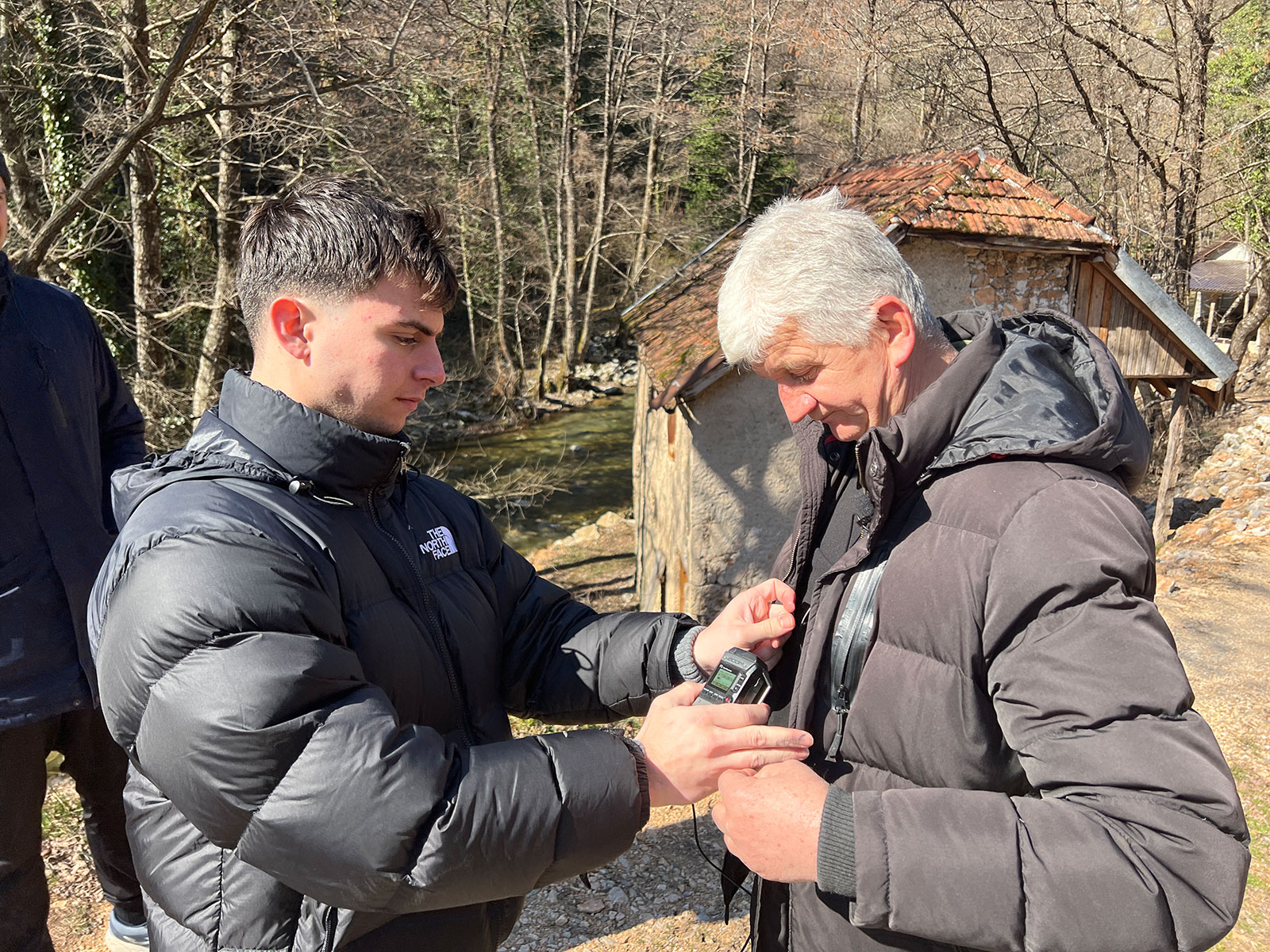 Giorgio Ghiotto mics up interview subject on the banks of the Nerevitca river