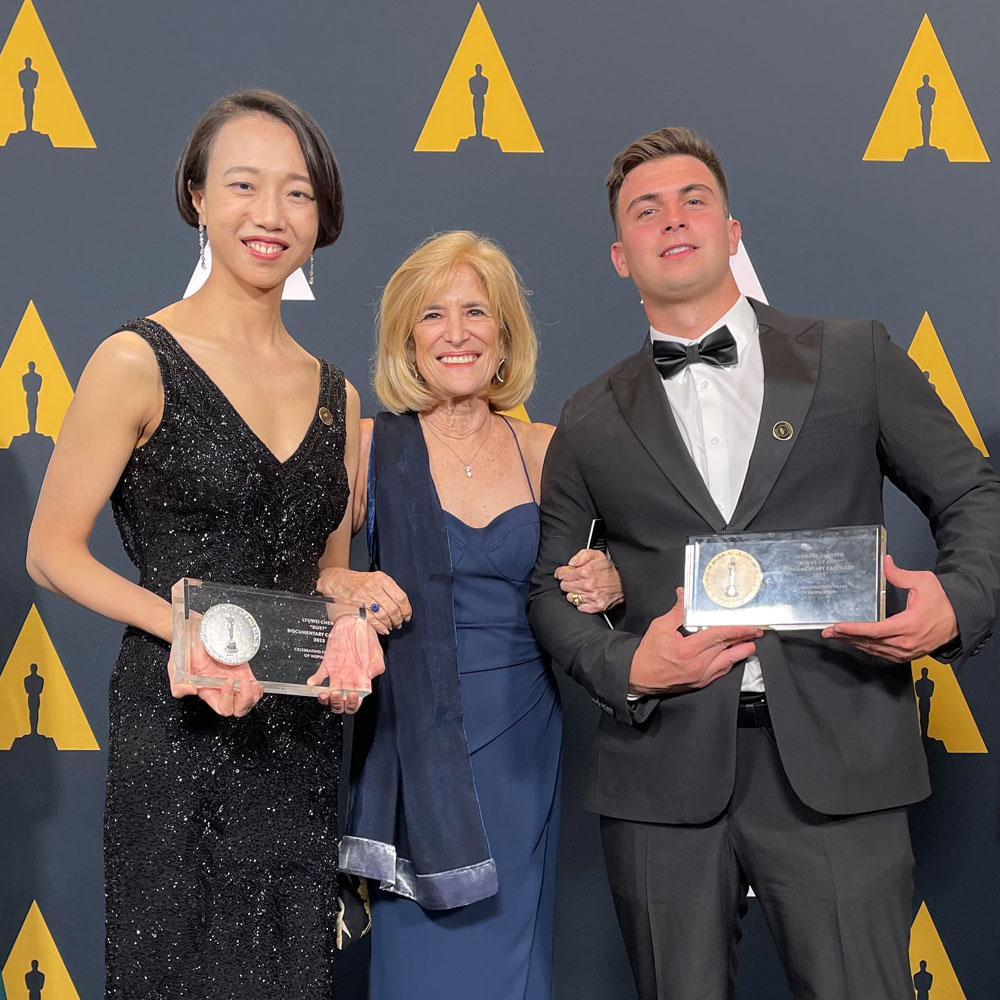 2023 Student Academy Awards winners Lyuwei Chen and Giorgio Ghiotto pictured with their awards, and NewDoc program director Marcia Rock.