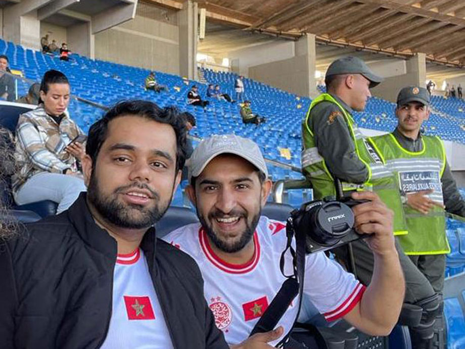 Said Latif and Rishabh Jain covering supporters of the Wydad Athletic Club, at Casablanca's Stade Mohammed V